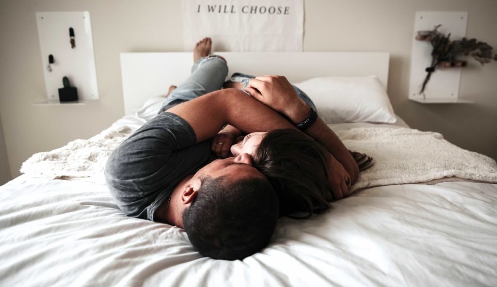 man and woman laying in bed